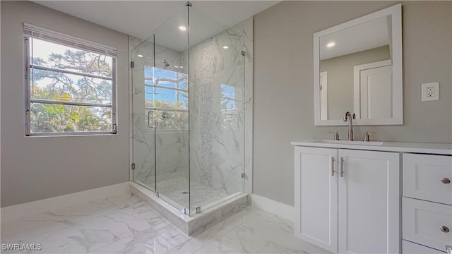 bathroom with vanity and a shower with door