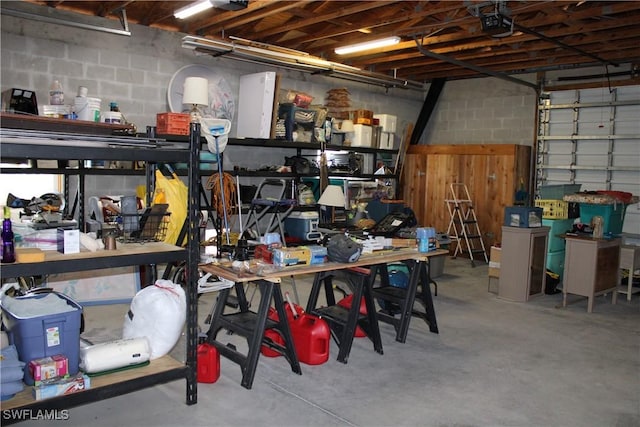 garage featuring a garage door opener and a workshop area