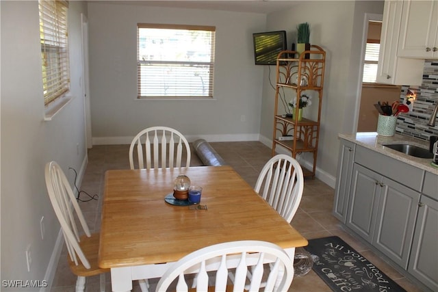 tiled dining area featuring sink