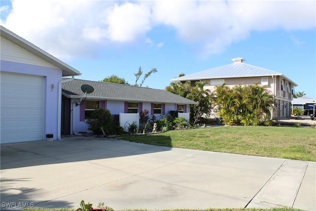 single story home with a garage and a front lawn