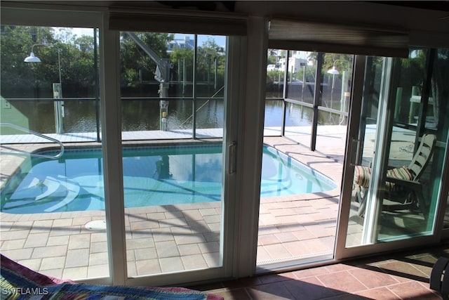 view of swimming pool with a water view and a wealth of natural light