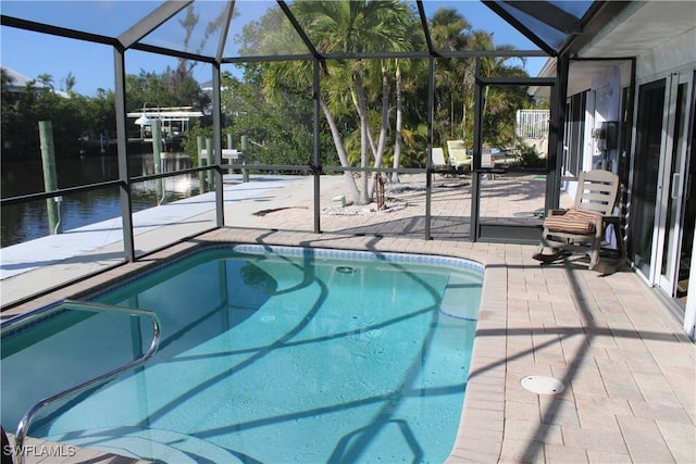 view of swimming pool with a water view, a lanai, and a patio area