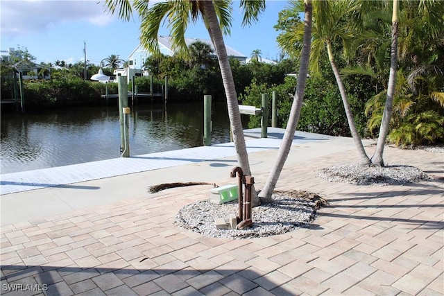 exterior space with a water view and a boat dock