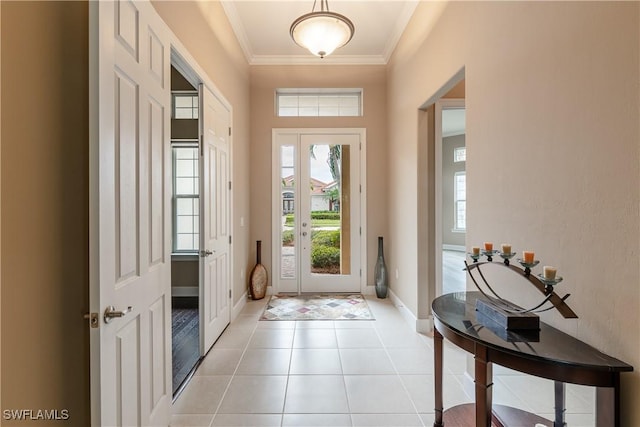 entryway with crown molding and light tile patterned floors