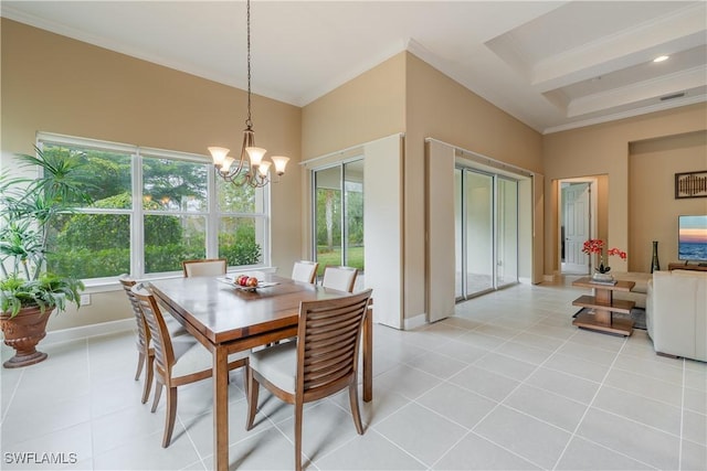 dining room with crown molding, a towering ceiling, light tile patterned floors, and a notable chandelier