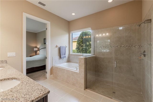 bathroom featuring tile patterned flooring, vanity, and shower with separate bathtub