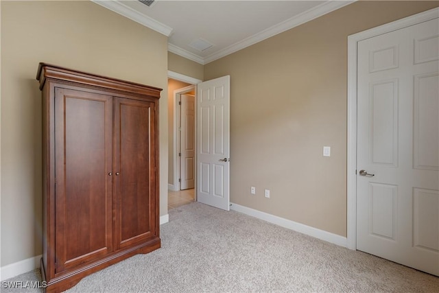 unfurnished bedroom with crown molding and light carpet