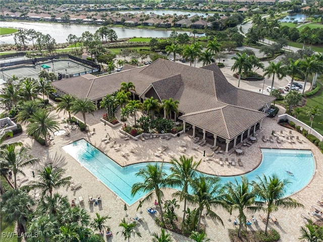 view of swimming pool with a patio and a water view