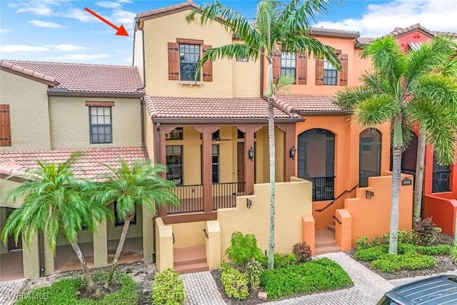 mediterranean / spanish-style home with a tiled roof and stucco siding