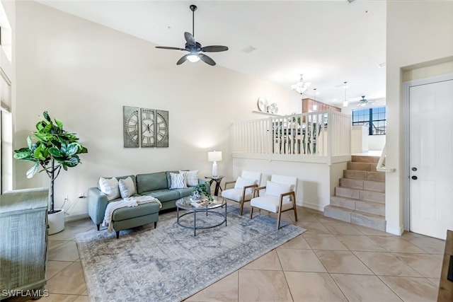 tiled living room featuring ceiling fan and high vaulted ceiling