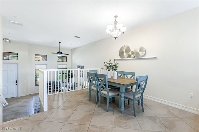 dining area featuring light tile patterned floors and ceiling fan with notable chandelier