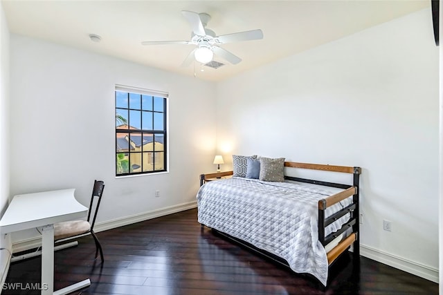 bedroom with dark hardwood / wood-style floors and ceiling fan