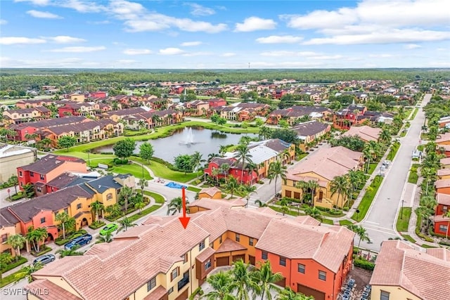 drone / aerial view with a water view and a residential view