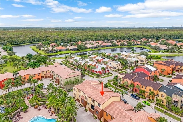 aerial view with a residential view, a water view, and a wooded view