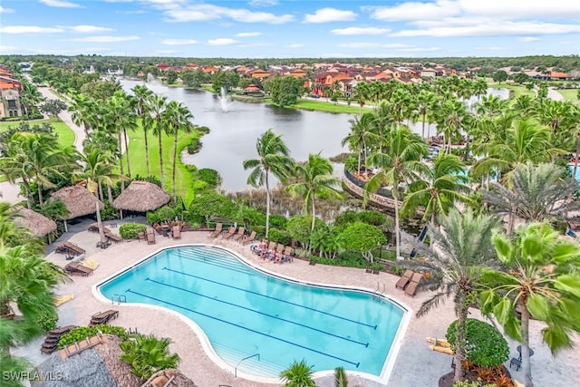 community pool with a patio area and a water view