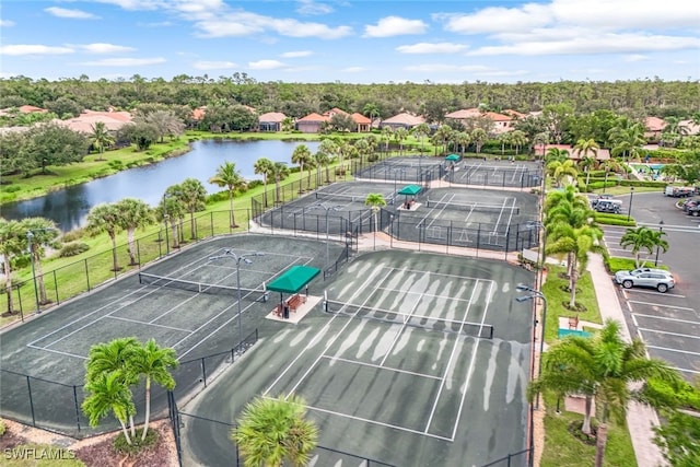 birds eye view of property with a water view and a residential view