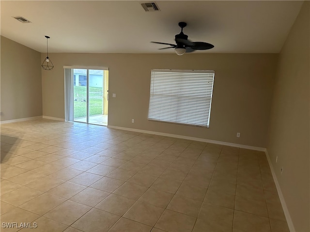 empty room featuring light tile patterned floors and ceiling fan