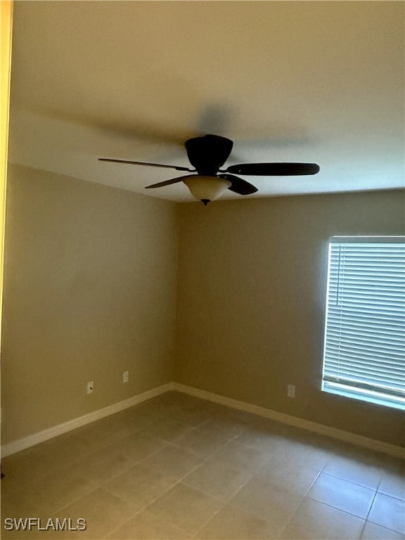 empty room featuring light tile patterned flooring and ceiling fan