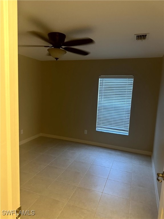 unfurnished room with light tile patterned flooring and ceiling fan