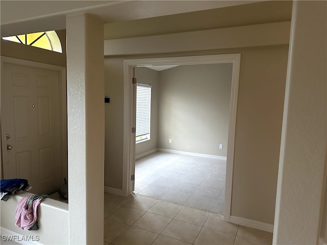 entryway with light tile patterned flooring