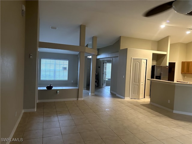 interior space with lofted ceiling and ceiling fan