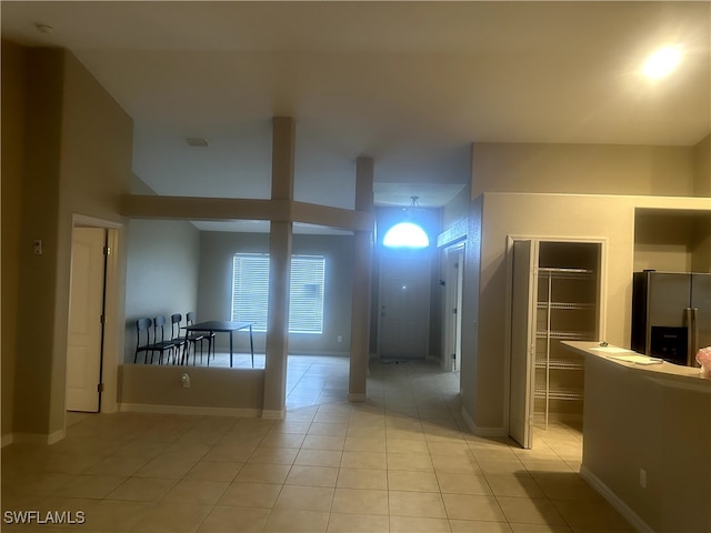 hall featuring light tile patterned flooring