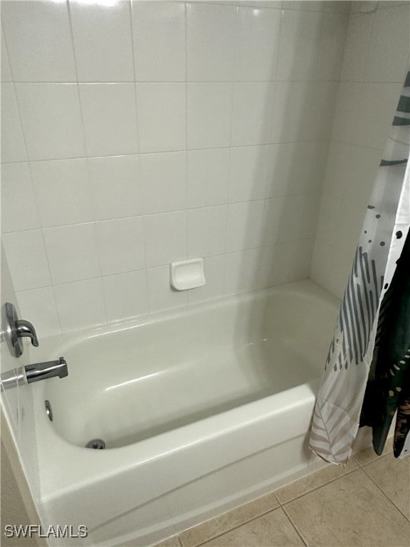 bathroom with tile patterned flooring and shower / bath combo