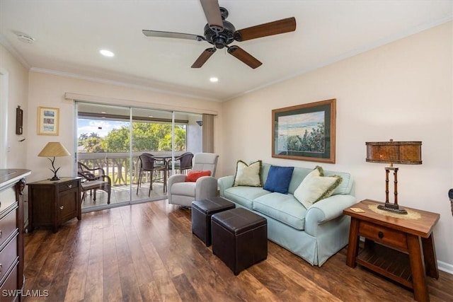 living room with dark hardwood / wood-style flooring, ornamental molding, and ceiling fan