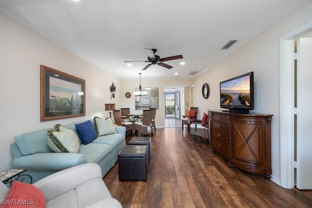 living room featuring crown molding, ceiling fan, and dark hardwood / wood-style flooring