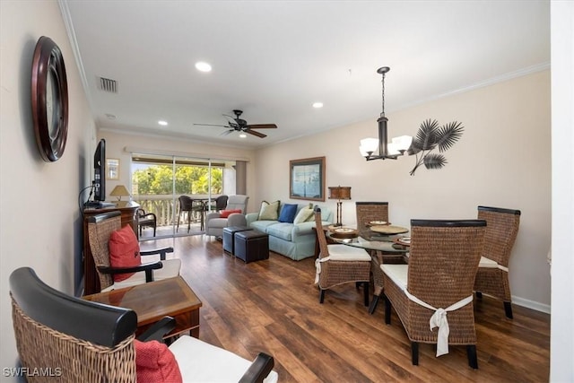 dining space with ornamental molding, ceiling fan with notable chandelier, and dark hardwood / wood-style flooring