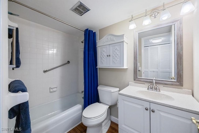 full bathroom featuring vanity, hardwood / wood-style flooring, toilet, and shower / bath combo