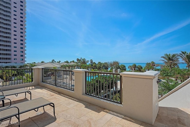 view of patio / terrace featuring a water view and a balcony