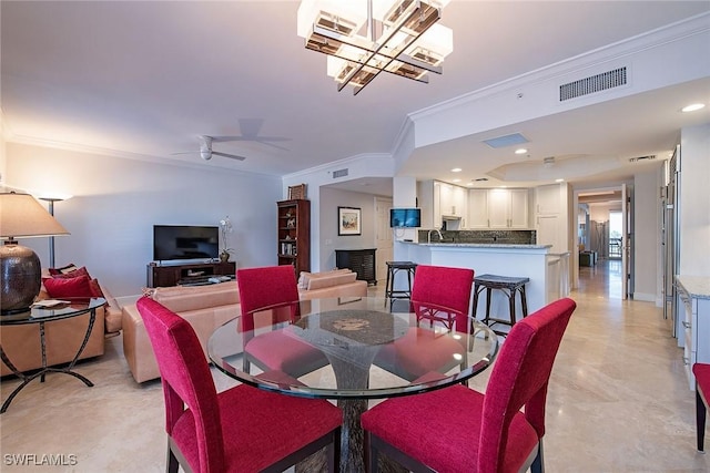 8473 Bay Colony Dr Unit 203, Naples, FL 34108 - dining space with crown molding and ceiling fan with notable chandelier
