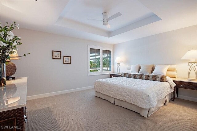 8473 Bay Colony Dr Unit 203, Naples, FL 34108 - bedroom with a raised ceiling, light carpet, and ceiling fan