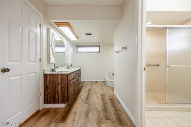 bathroom with vanity, hardwood / wood-style floors, and walk in shower