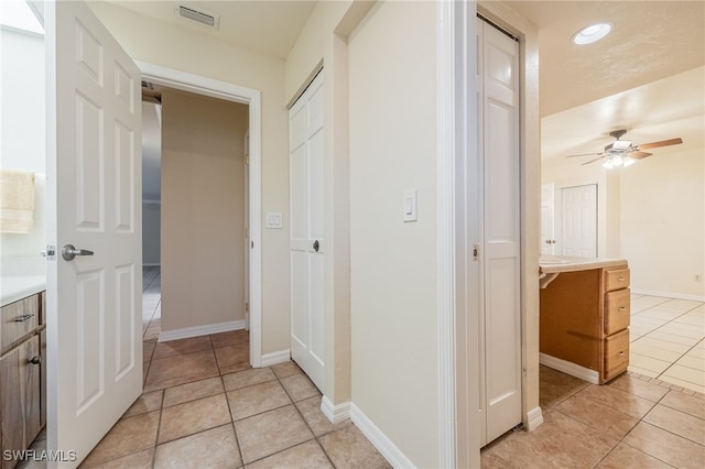 corridor featuring light tile patterned flooring