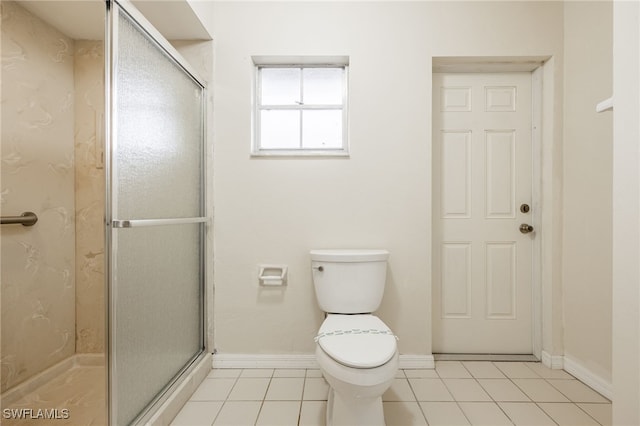 bathroom featuring walk in shower, toilet, and tile patterned flooring