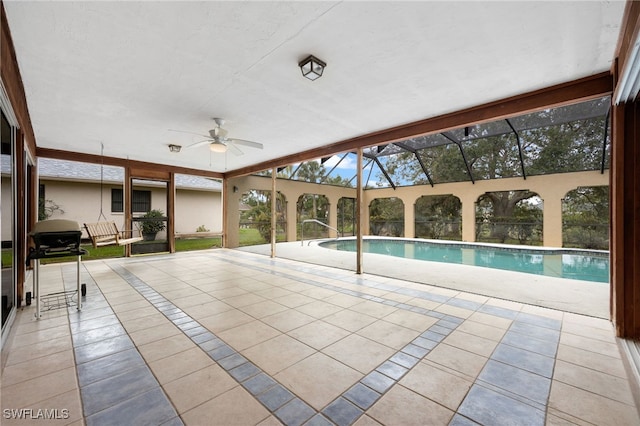 view of swimming pool with a patio, a lanai, a grill, and ceiling fan