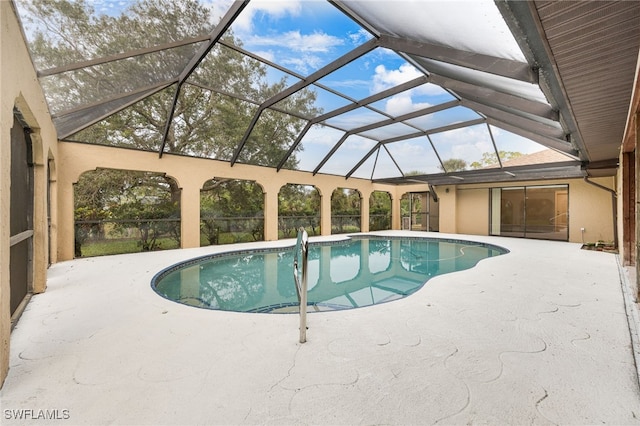 view of pool featuring a patio area and glass enclosure