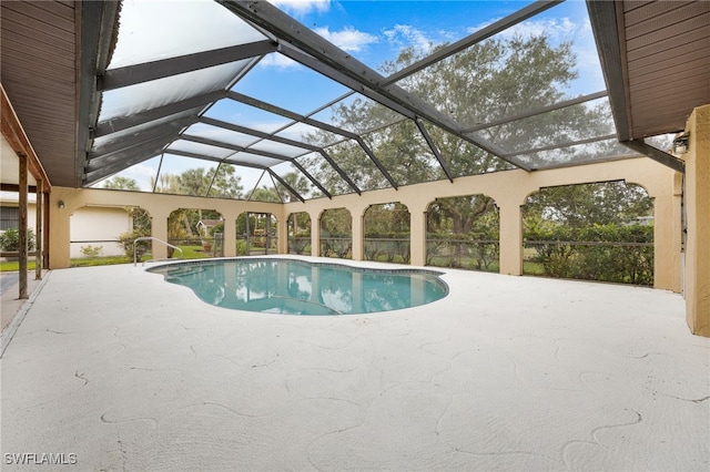 view of pool featuring a patio and glass enclosure