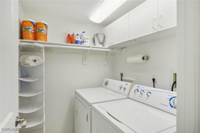 15400 River Vista Dr Unit 301, North Fort Myers, FL 33917 - laundry area featuring washing machine and clothes dryer and cabinet space