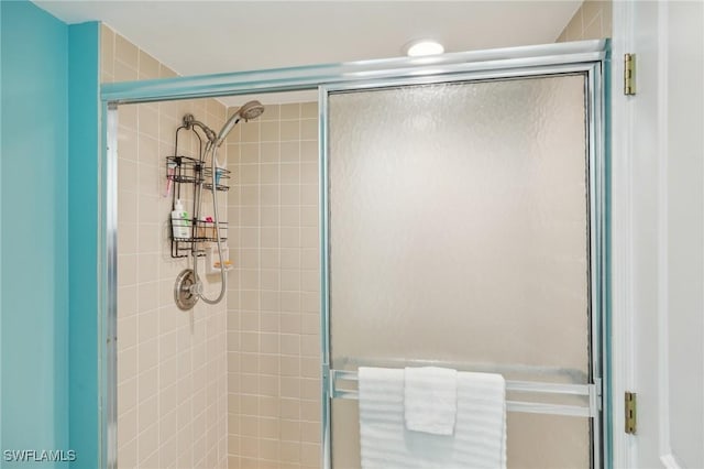 bathroom with a shower with shower door