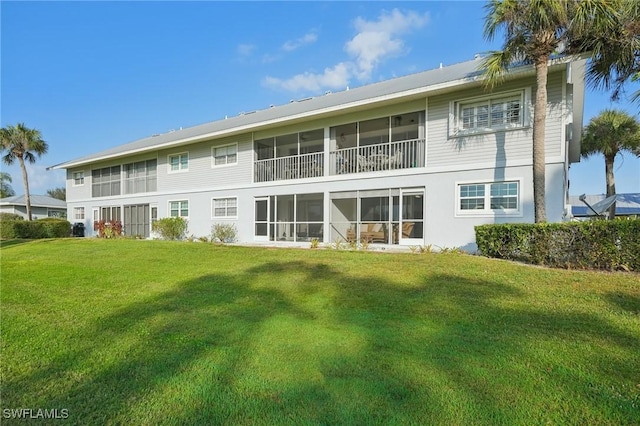 15400 River Vista Dr Unit 301, North Fort Myers, FL 33917 - rear view of property featuring a lawn