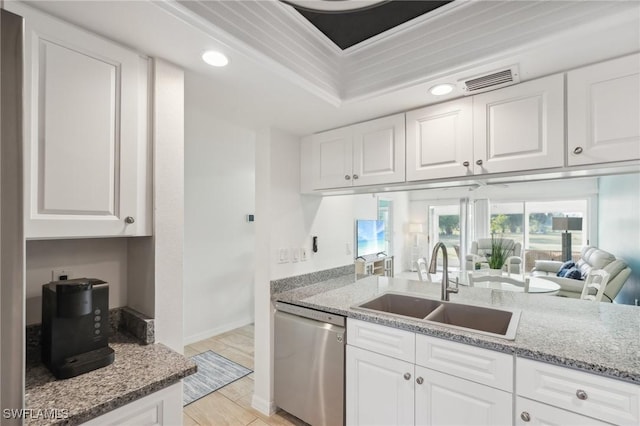 kitchen with sink, white cabinetry, light stone counters, a raised ceiling, and dishwasher