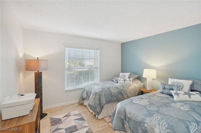 15400 River Vista Dr Unit 301, North Fort Myers, FL 33917 - bedroom with a textured ceiling and baseboards