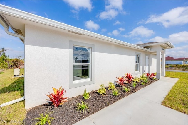 view of property exterior with a lawn