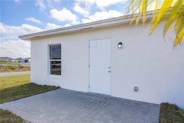 doorway to property with a patio area