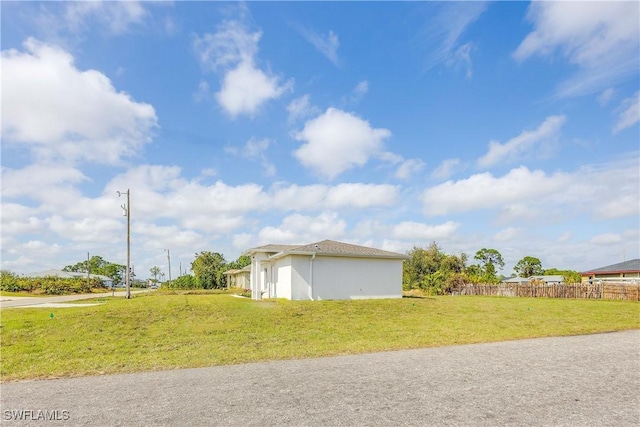 view of property exterior with a lawn