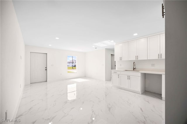 kitchen with white cabinetry and sink