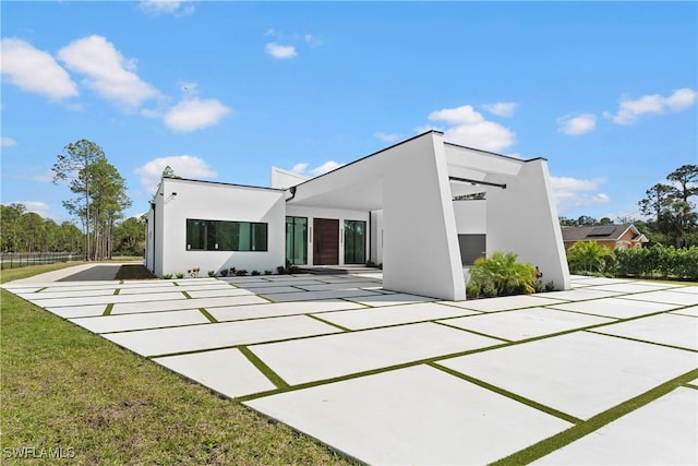 rear view of property with a lawn